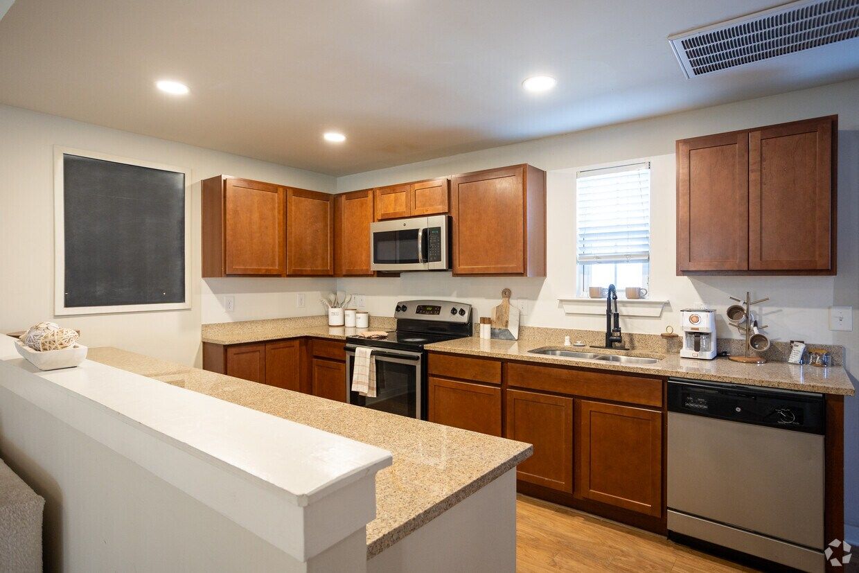 Kitchen with wood cabinets, granite counters, and stainless steel appliances