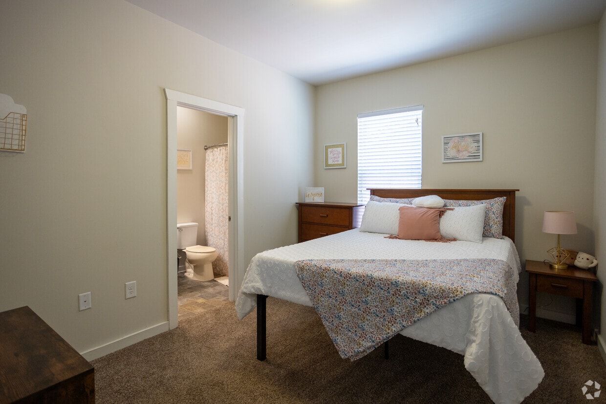Bedroom with a queen bed and an attached bathroom