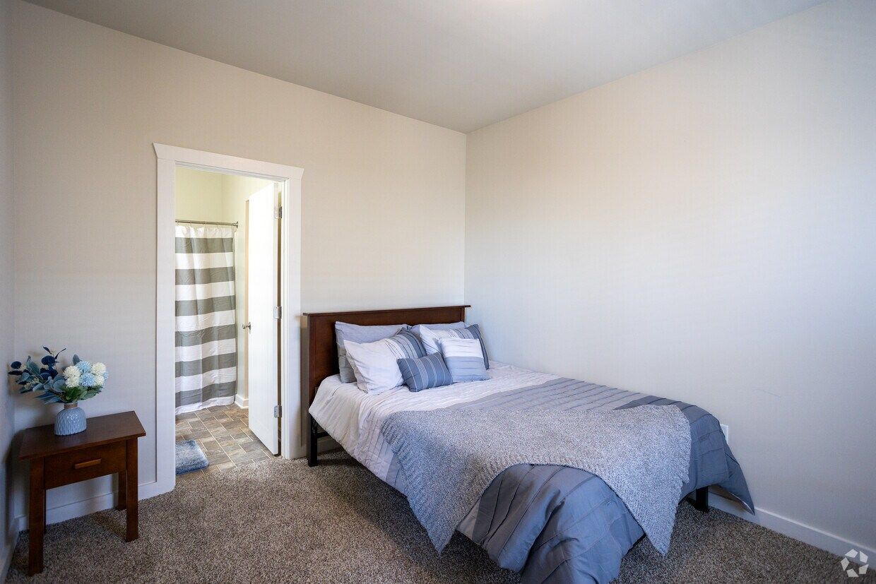 Bedroom with a queen bed and an attached bathroom