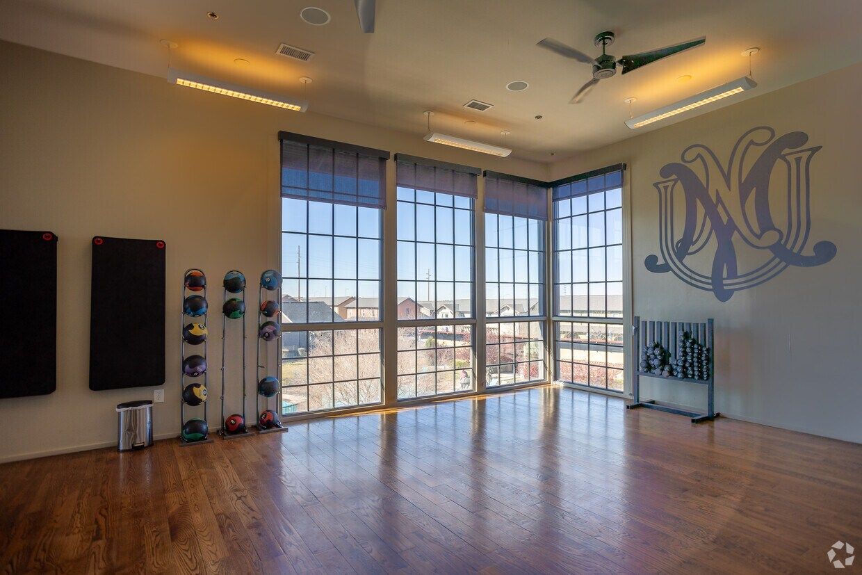 Yoga studio with wood floors and tall windows